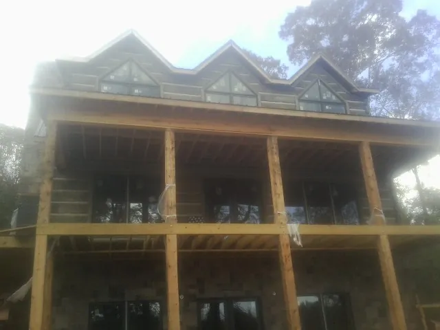 Dormers and porch framing on a large log home under construction in Huntland