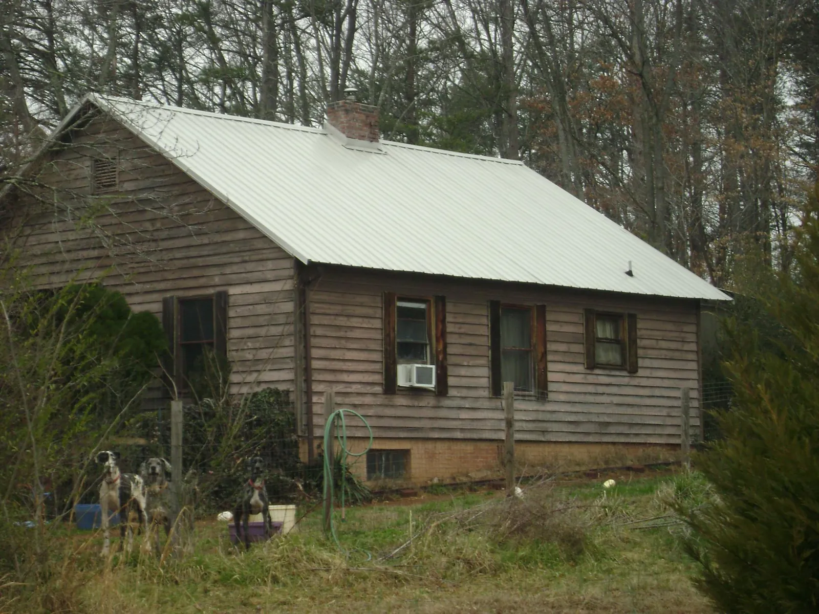 White metal roof on an old wood sided farmhouse, from a Metal Roof Installation job in Huntland